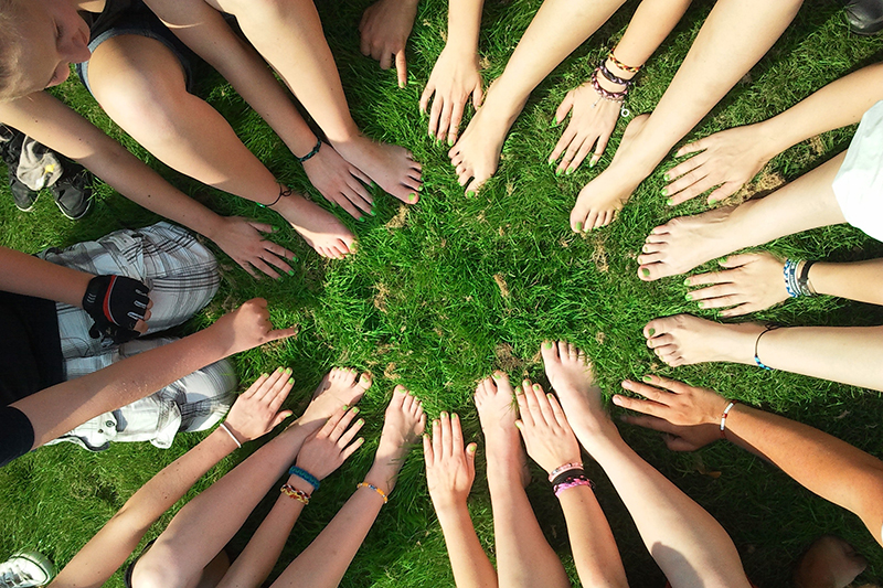 Hands in a circle in the grass